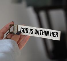 a person holding a white belt with the words god is within her