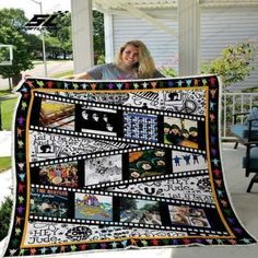 a woman is holding up a quilt made with film strips and photos from movies on it