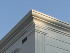 a bird is perched on the corner of a building