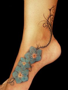 a woman's foot with blue flowers on it