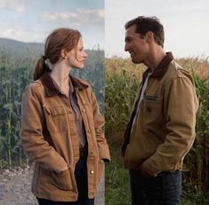 a man and woman standing in front of a corn field looking into each other's eyes