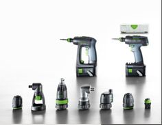 various electric tools are displayed on a white surface with black and green trimmings