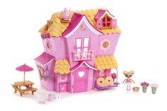 a pink dollhouse with furniture and accessories on a white background for dolls to play in