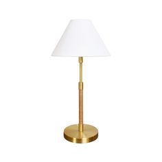 a gold table lamp with a white shade on the base and a wooden stick sticking out of it