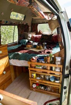 the interior of an old van with lots of stuff in it's bed area