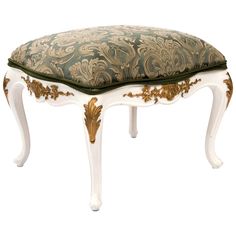 a white bench with a green and gold cushion on it's seat cover,