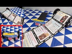 a table topped with two pieces of paper next to a toy car on top of a blue and white checkered floor