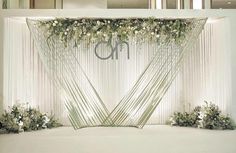 an elegant wedding backdrop with flowers and greenery