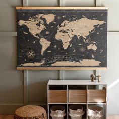 a world map hanging on the wall above a shelf