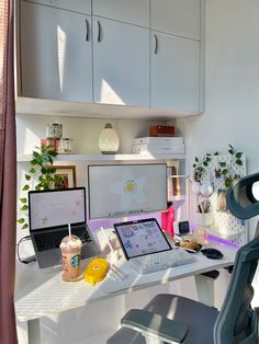 a desk with two laptops and a monitor on it