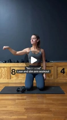 a woman is doing yoga in front of a blackboard