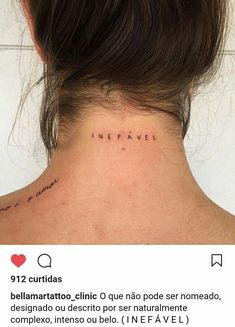 the back of a woman's neck with words written in cursive ink