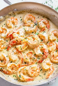 a skillet filled with shrimp and sauce