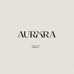 the word aurora is written in black ink on a white paper with an oval shape