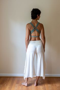 A top-selling tank from our shop for over a decade, this strappy yoga tank is made from the highest quality sustainably sourced cotton lycra blend.  The woven back adds a unique flair. Great for yoga, pilates & dance. Also looks amazing under backless tops. Paramita Designs clothing makes for excellent travel wear on your next adventure! Shown here in Sage with the white Mini Skirt and Ruffle Pants. Hand or machine wash cold delicate cycle. While drying on a gentle cycle will not damage the top, the longevity of the top will be maintained by hanging to dry.  Fair Trade - Handmade - Sustainable Womens Yoga Outfits, Seamless T-back Halter Top For Yoga, Summer Yoga Tank Top With Built-in Bra, Yoga Crop Top With Built-in Bra And Strappy Back, Yoga Teacher Aesthetic Outfit, Summer Gym Crop Top With Strappy Back, Athleisure Crop Top With Adjustable Straps For Yoga, Summer Activewear With Adjustable Straps And Cross Back, Summer Activewear With Adjustable Cross-back Straps