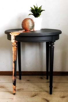 a small table with a potted plant on it