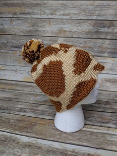 a brown and white knitted hat on top of a head