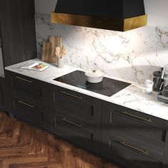 a kitchen with marble counter tops and black cabinets