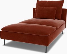 a red chaise lounge with two pillows on it's back and one arm