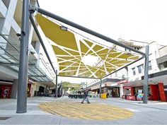 a yellow and white umbrella on the side of a building