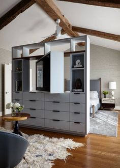 a living room filled with furniture on top of a hard wood floor covered in furnishing