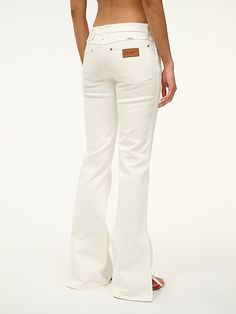 THE BIKINI JEAN The Bikini Jean is our snug fit. This low-rise jean sits below the natural waist, is fitted through the hips, with a flared leg. This style is available in 2 inseam lengths and features our STAUD belt loop detail at the waist, as well as slit detailing at the bottom of each pant leg. White Wrangler, White Flare Jeans, White Flared Jeans, Low Rise Jean, Jean Belts, Wrangler Jeans, Cute Fits, Snug Fit, Flare Jeans