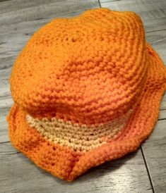 Crochet orange and yellow bucket hat is a small child's size 5 and a half inches. Handmade Orange Hat For Spring, Orange Brimmed Bucket Hat For Spring, Casual Orange Crochet Hat For Beach, Handmade Yellow Wide Brim Bucket Hat, Orange Crochet Hat One Size Fits Most, Orange Crochet Hat For Spring, Casual Orange Bucket Sun Hat, Casual Orange Crochet Beach Hat, Handmade Orange Crochet Hat For Beach