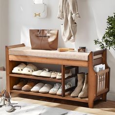 a wooden bench filled with shoes next to a potted plant and purse on top of it