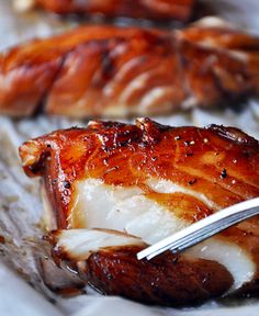 a piece of meat is being eaten with a fork