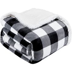 two black and white buffalo plaid blankets folded on top of each other, one with a sherpack