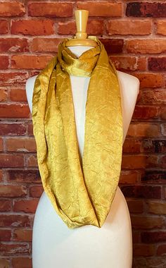 Our Classic Infinity Scarf won't disappoint.  They are 70" long and can be wrapped up to three times around your neck.  Wear one loop across the body like a sash or leave it straight and wear it as a shawl, loop it twice around the neck in the typical infinity style, or wear it as three loops around the neck for a close-fitting cowl style scarf.  Measuring 10" wide, this item can be worn as a traditional infinity scarf, although the extra wide design allows it to be thrown on as a shawl or to fu Scarf Autumn, Gold Scarf, Style Scarf, Soft Scarf, Shiny Fabric, Dark Shades, Shades Of Yellow, Neck Warmer, Scarf Styles