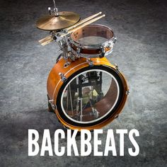 an orange drum set with the words backbeats on it's front side