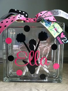 a clear square box with black and pink decorations