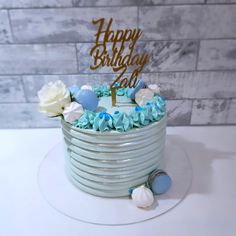 a birthday cake with blue and white frosting