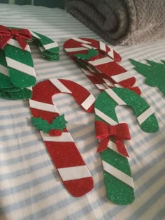 some candy canes and christmas decorations on a bed