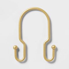 a pair of brass hooks on a white background