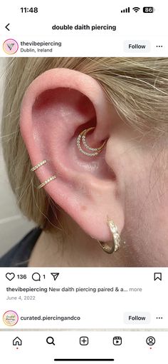 an ear with three different types of piercings on it, and one is in the middle