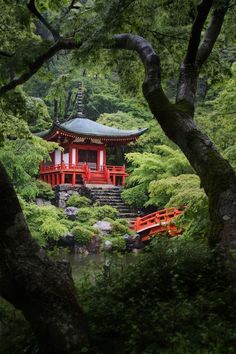 a red building surrounded by trees and bushes