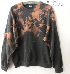 a black and brown tie dye sweater hanging on a wall