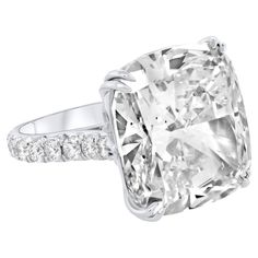 a cushion cut diamond ring with diamonds around it