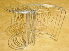 a set of four metal racks with rings on them