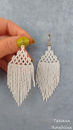 a pair of white beaded fringe earrings