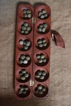 two wooden trays filled with eggs sitting on top of a table next to a spoon