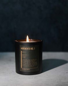 a candle that is sitting on top of a table with the words, mementoo no 1