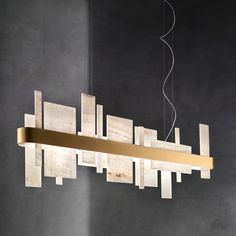 a modern chandelier made out of wood blocks and metal strips hanging from the ceiling