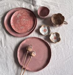 three plates and two spoons on a table