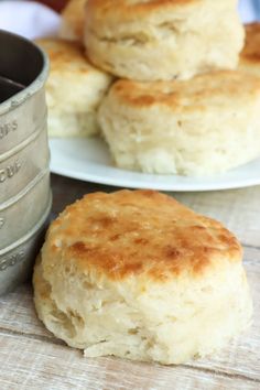 some biscuits are sitting on a table next to a cup