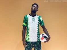 a young man holding a soccer ball in his right hand and wearing green patterned shorts