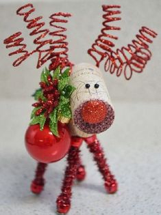 a red ornament with a christmas decoration on it's head and legs