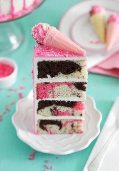 a slice of cake with pink and white frosting